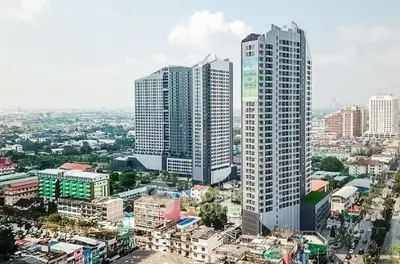 Stunning aerial view of modern high-rise buildings in a bustling urban area, showcasing prime real estate.