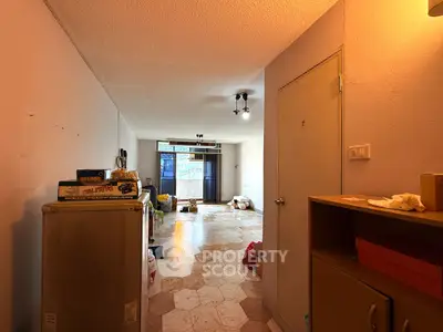 Spacious living room with unique flooring and ample natural light, perfect for modern living.