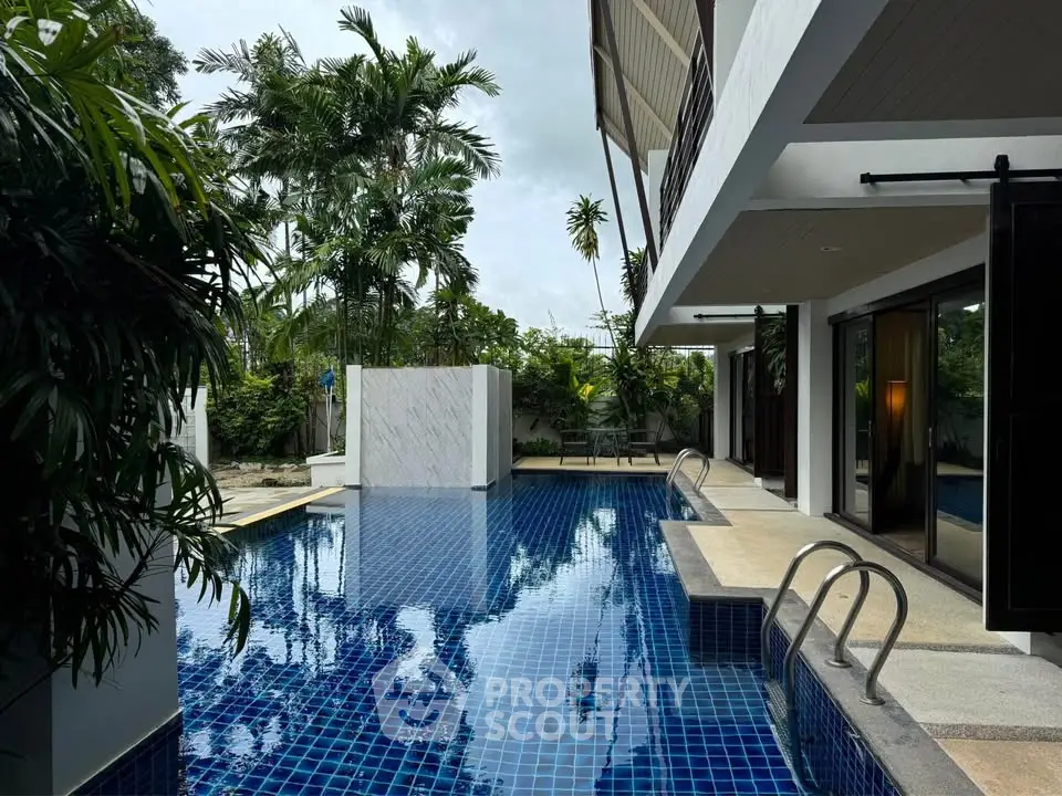 Luxurious modern home with stunning pool and lush greenery