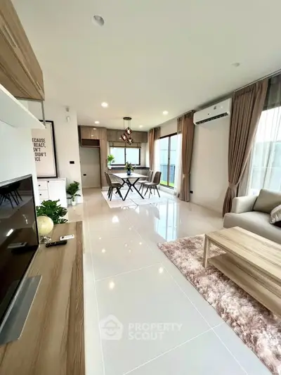 Modern open-plan living and dining area with sleek furnishings and natural light.