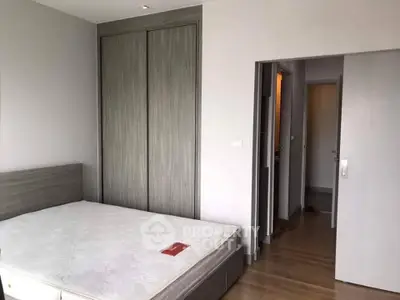 Spacious bedroom with modern wooden flooring and built-in wardrobe, perfect for comfortable living.