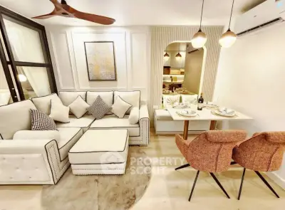 Elegant living room with cozy dining area, modern decor, and stylish lighting in a contemporary apartment.