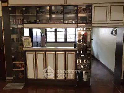 Charming interior with elegant built-in shelves and wooden flooring, perfect for cozy living spaces.