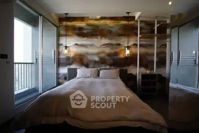 Luxurious bedroom with artistic wall design and modern lighting, featuring a cozy bed and balcony access.