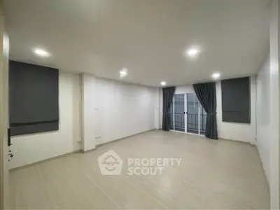 Spacious unfurnished living room with large windows and modern flooring