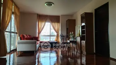 Spacious living room with elegant wooden flooring and large windows