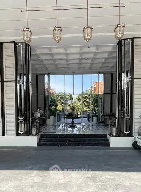 Luxurious building entrance with modern design and elegant lighting fixtures.