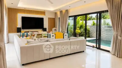 Luxurious living room with pool view, featuring elegant decor and spacious seating area.
