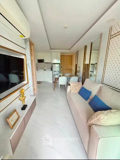 Modern living room with elegant decor, open kitchen layout, and stylish furniture in a bright apartment.