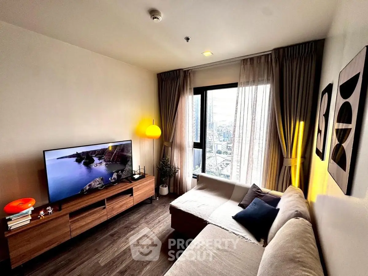 Modern living room with city view, cozy sofa, and stylish decor