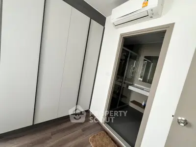 Modern bedroom with sleek wardrobe and air conditioning unit