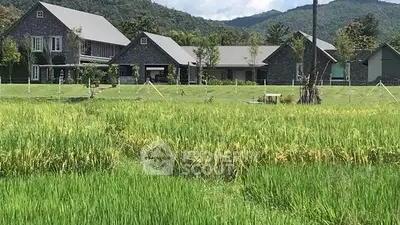 Stunning countryside estate with lush green fields and mountain backdrop