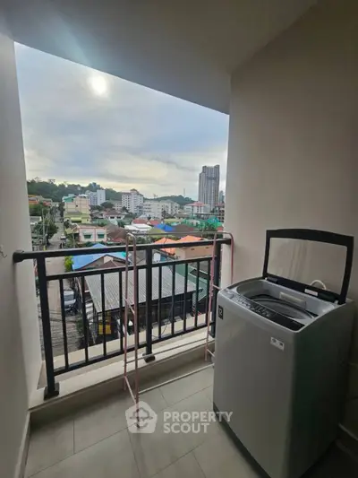 Spacious balcony with washing machine and stunning city view