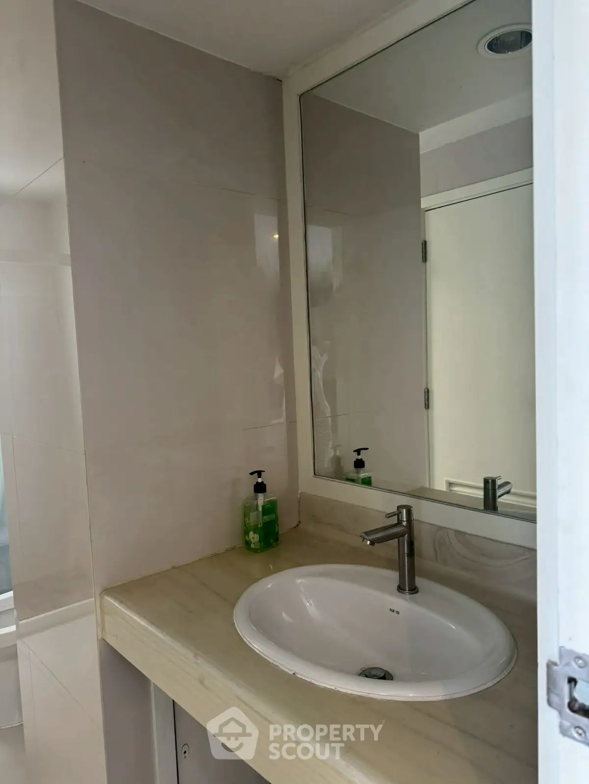 Modern bathroom with sleek sink and large mirror
