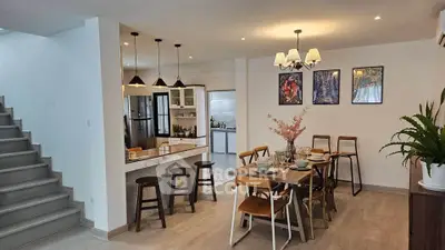 Stylish open-plan dining area with modern kitchen and elegant decor