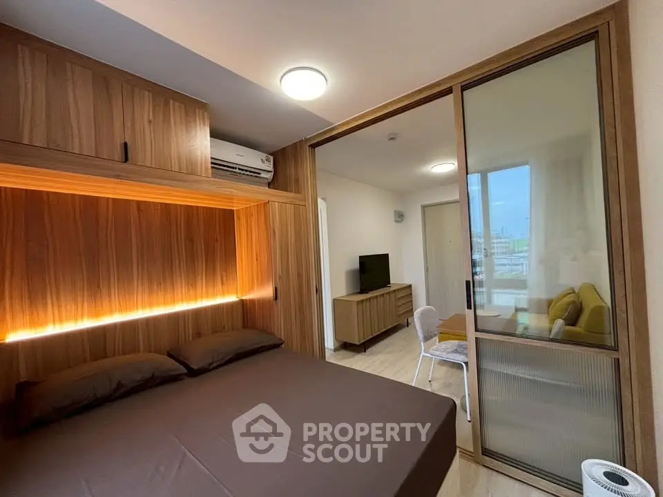 Modern bedroom with sliding glass door and built-in wooden storage