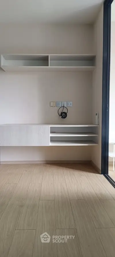 Modern minimalist study area with built-in shelves and wooden flooring