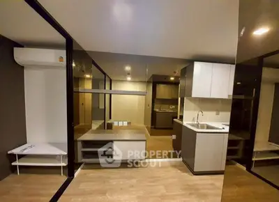 Modern open-layout living space with sleek kitchen and stylish flooring