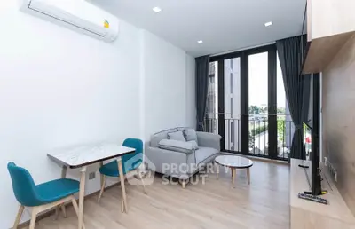 Modern living room with stylish furniture and large windows offering a bright and airy atmosphere.