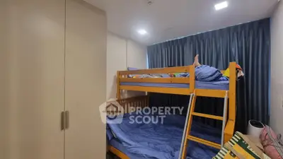 Cozy bedroom with bunk beds and ample closet space, perfect for maximizing small living areas.