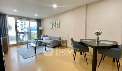 Spacious modern living room with balcony view in urban apartment