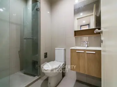 Modern bathroom with glass shower and sleek vanity in contemporary home