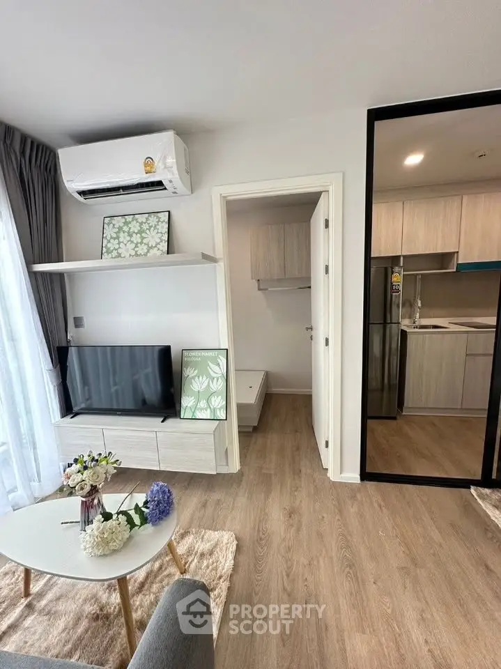 Modern living room with stylish decor and open kitchen layout in a contemporary apartment.