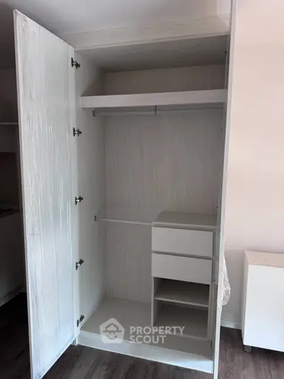 Spacious modern wardrobe with shelving and hanging space in a stylish interior.