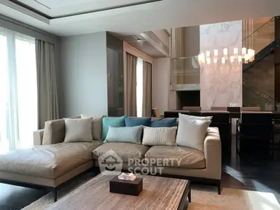 Luxurious modern living room with elegant sofa and stylish dining area, perfect for sophisticated living.