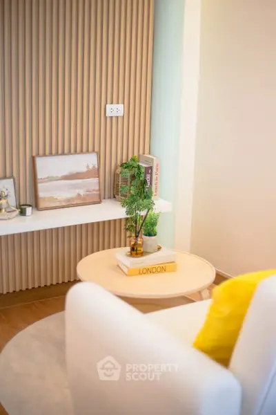 Stylish modern living room corner with elegant decor and cozy seating, perfect for relaxation.