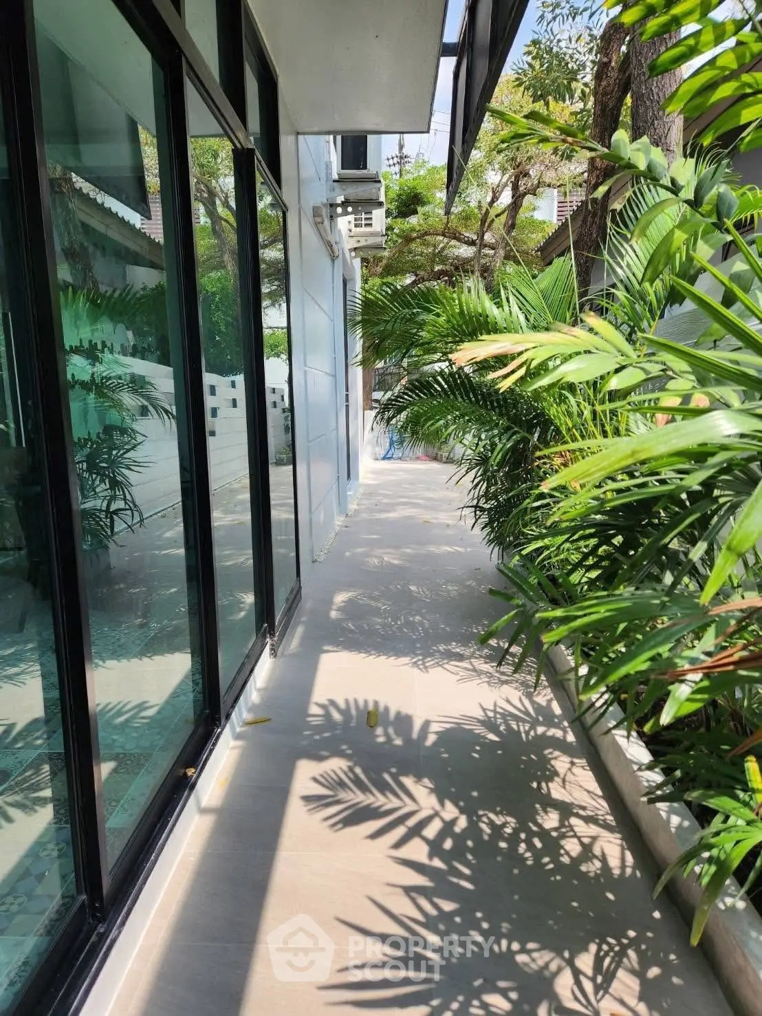 Modern building exterior with lush greenery and glass facade