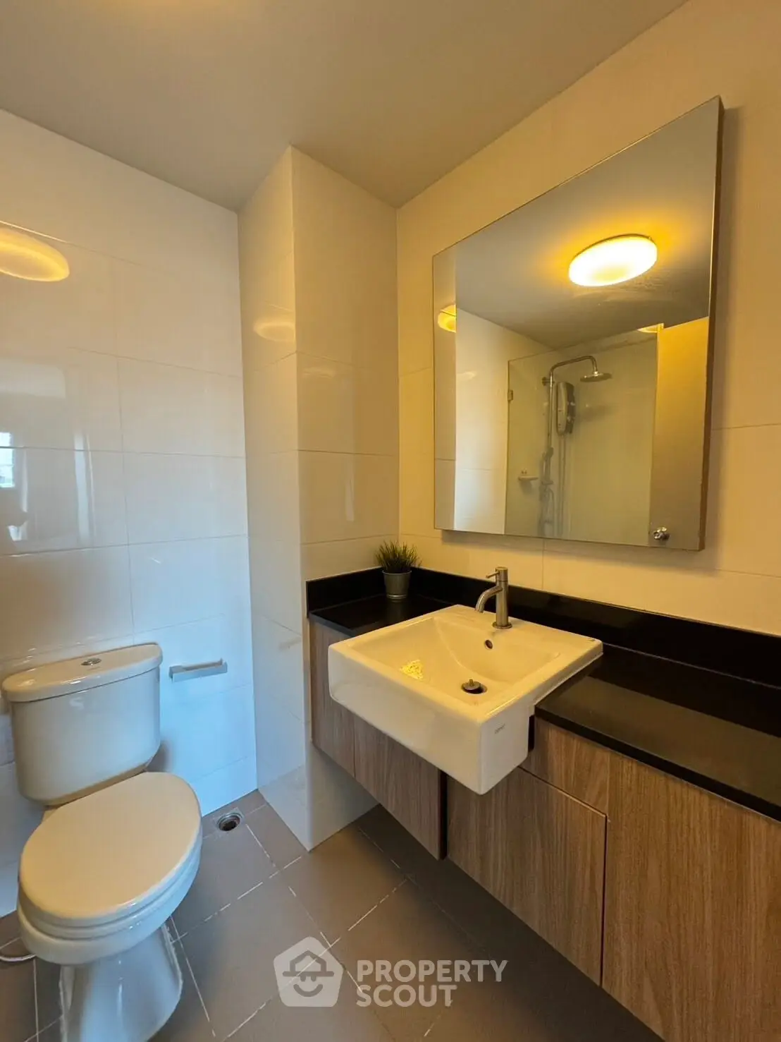 Modern bathroom with sleek fixtures and elegant design, featuring a spacious shower and stylish vanity.