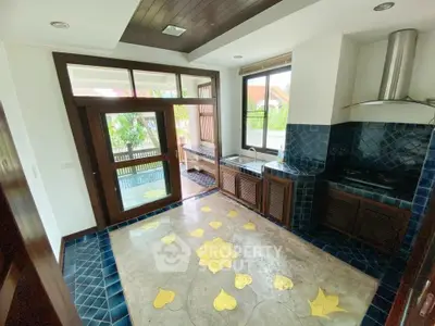 Charming kitchen with unique tile flooring and open layout, featuring modern appliances and garden view.