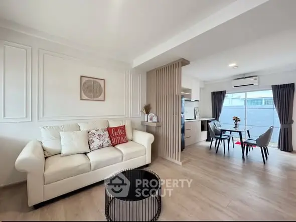 Modern open-plan living room with stylish decor and dining area