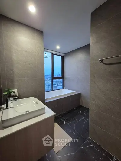 Luxurious bathroom with city view, modern fixtures, and elegant tile design.