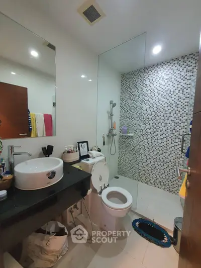 Modern bathroom with sleek fixtures and glass shower enclosure