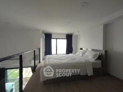 Spacious modern bedroom with large window and elegant decor