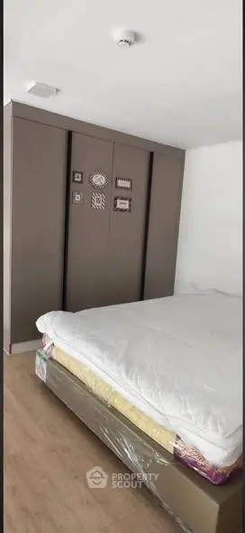 Modern bedroom with sleek wardrobe and comfortable bed in a stylish apartment.