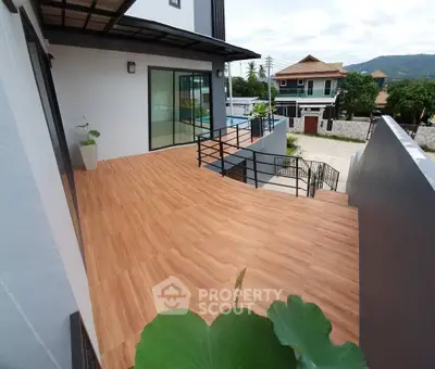 Spacious balcony with modern design and scenic view in a contemporary home.