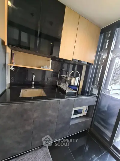 Modern kitchen with sleek cabinetry and built-in appliances in a stylish apartment.