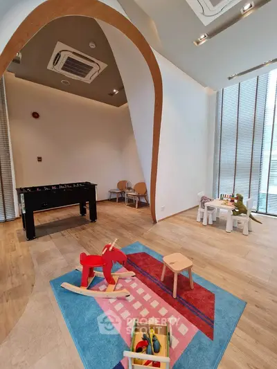 Modern playroom with wooden toys and colorful rug in a stylish apartment building