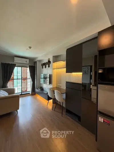 Modern living room with stylish decor and open layout, featuring natural light and contemporary furniture.