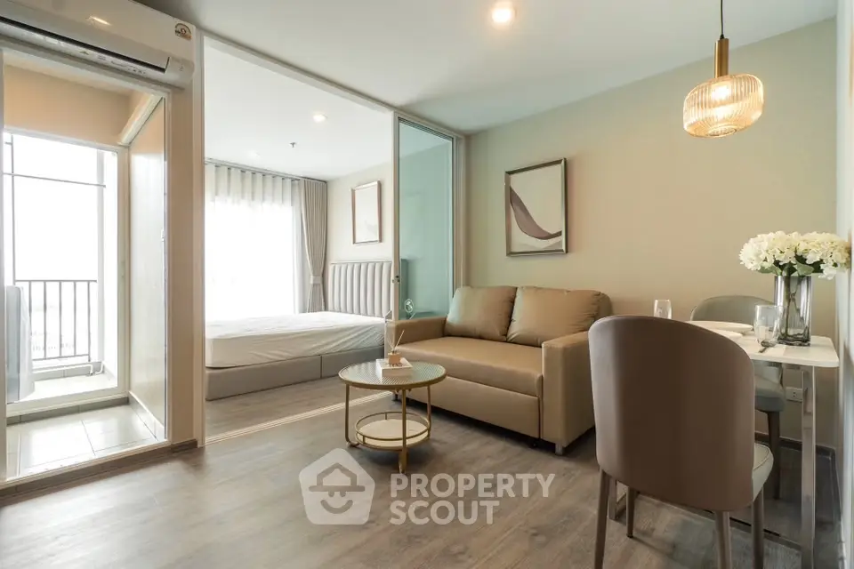 Modern open-plan living room with elegant decor and balcony view