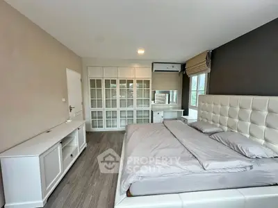 Spacious modern bedroom with elegant decor and large wardrobe
