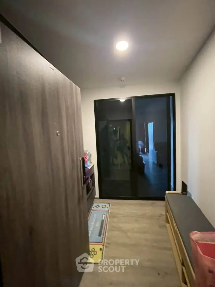 Modern apartment entrance with sleek wooden door and hallway