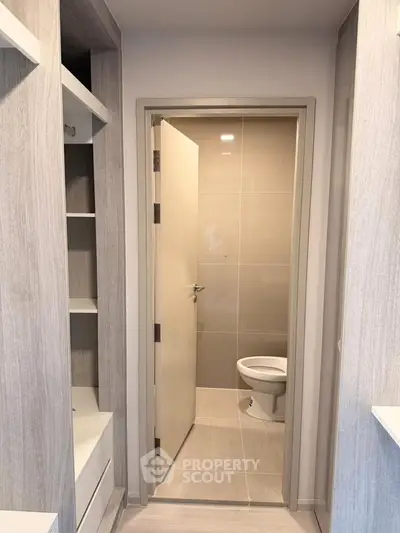 Modern bathroom entrance with sleek design and neutral tones