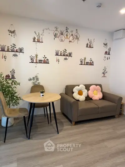 Charming living room with cozy sofa and floral wall art, perfect for relaxation.