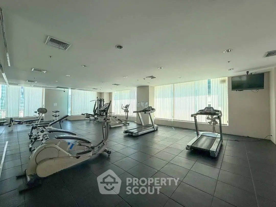 Spacious modern gym with natural light and state-of-the-art equipment
