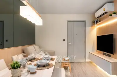 Modern living room with stylish decor and dining area, featuring sleek furniture and ambient lighting.
