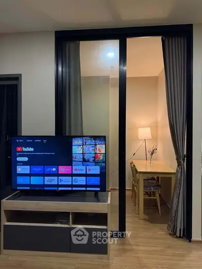 Modern living room with TV and cozy study nook, perfect for relaxation and productivity.